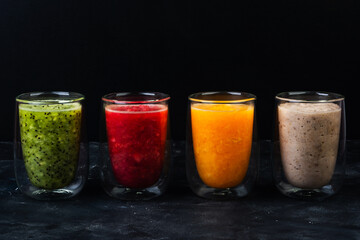 Smoothies in double-wall glasses of kiwi, Sicilian orange, mandarin and banana
