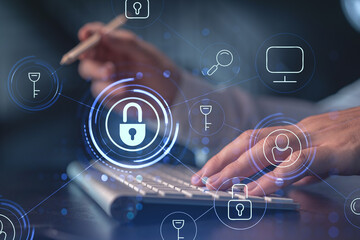 A programmer is typing a code on computer to protect a cyber security from hacker attacks and save...