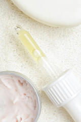 Nourishing and hydrating facial serum, antirid cream and facial sponge, close up image. 