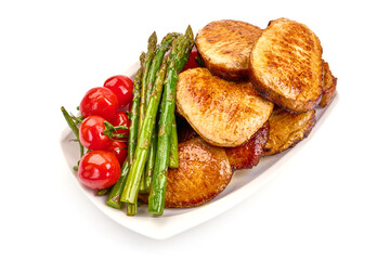 Roasted juicy pork steaks with asparagus, isolated on white background. High resolution image