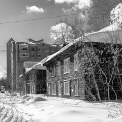 Old wooden houses under the snow. Russia. Siberia. Winter. The city of Tomsk 2021. Multifamily residential wooden houses of the 19th century.