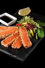 Salmon Tataki Japanese food salmon fillet on a black background for the menu