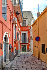 A narrow street among the old houses of Venosa, a medieval village in the Basilicata region, Italy.