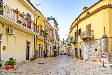 A narrow street among the old houses of Venosa, a medieval village in the Basilicata region, Italy.