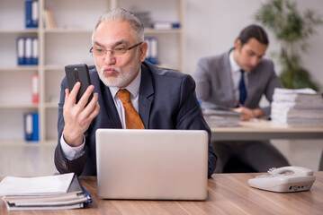 Two employees sitting at workplace