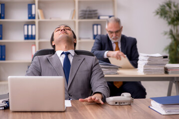 Two employees sitting at workplace