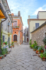 A narrow street among the old houses of Venosa, a medieval village in the Basilicata region, Italy.