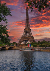 View of Eiffel Tower and river Seine at sunset in Paris, France. Eiffel Tower is one of the most iconic landmarks of Paris