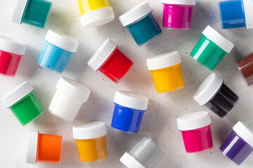 Multicolored gouache cans background. Arts, schools and education. White background. flat lay