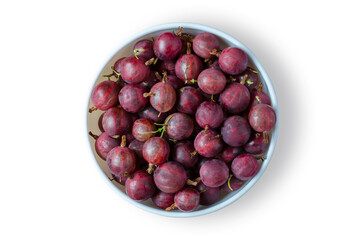 Red gooseberry. Ripe berries in a white plate. Isolated on white