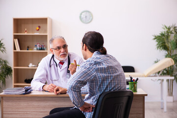 Young male patient visiting aged male doctor