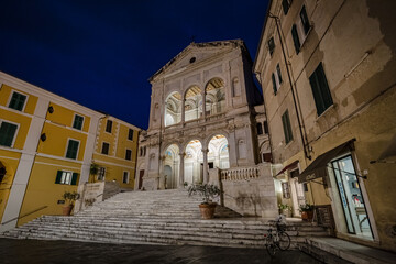 Cityscape. View of facade exterior of Saint Peter and Francis cathedral (Duomo) at night...