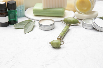 Natural organic skin care product. Home spa and self care concept. Facial serums, creams, jade roller and soap bars with copy space.