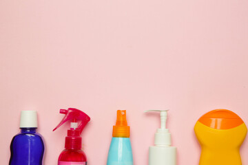 Colorful cosmetic products on bright pink background, top view with copy space.
