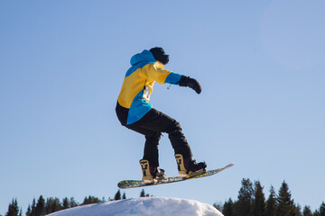 A snowboarder on a snowboard. Extreme winter sports.Rest in winter.