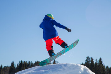 A snowboarder on a snowboard. Extreme winter sports.Rest in winter.