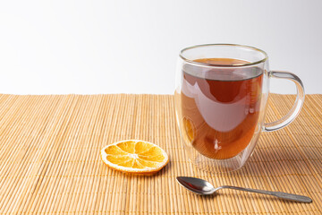 glass thermo mug with black tea on the table