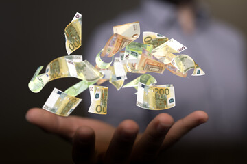 euro bills flying around  in hand