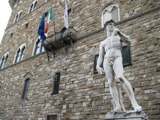 Statue of David before Palazzo Vecchio.  Building in Florence, on Piazza della Signoria. Scenic landscape with Town Hall. Travel to European Union. UNESCO World Heritage Site.