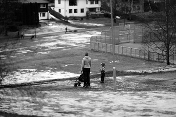 Black and white street photo of mother and son