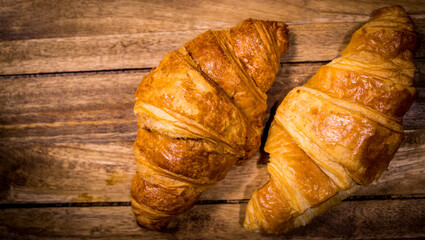 Freshly baked French croissants on a wooden table - studio photography