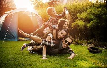 Fotobehang Cheerful family realxing on a camp © konradbak