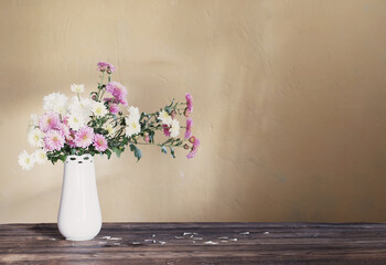 chrysanthemums in  vase on old wooden table