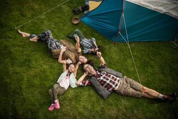 Fototapeten Cheerful family realxing on a camp © konradbak