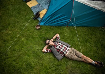 Foto op Canvas Relaxed man resting on a fresh, green lawn © konradbak