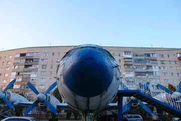 An old plane that stands as a monument in the city. Dream fly concept. Copy space. 