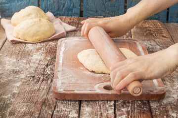 Empty space for text. Rolling out the dough on the table.