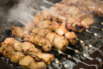 Marinated shashlik preparing on a barbecue grill over charcoal. Shashlik or Shish kebab popular in Eastern Europe. Shashlyk (skewered meat) was originally made of lamb. Roast Beef Kebabs On BBQ Grill.
