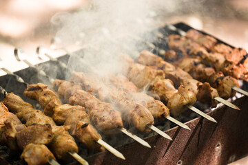 Marinated shashlik preparing on a barbecue grill over charcoal. Shashlik or Shish kebab popular in Eastern Europe. Shashlyk (skewered meat) was originally made of lamb. Roast Beef Kebabs On BBQ Grill.
