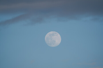 Big Moon with some clouds and blue sky at the afternoon