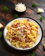 Classic Pasta carbonara with bacon, egg, cream, black pepper and Parmesan Cheese on plate. Italian food