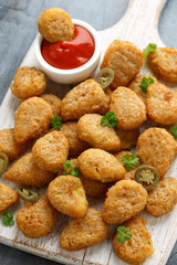 Crispy Jalapeno Popper with creamy cheese battered on white wooden board