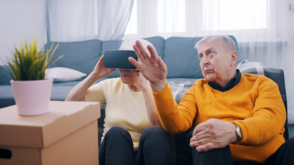 Senior mature couple having fun with virtual reality glasses . High quality photo