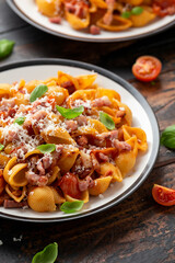 Conchiglie alla Amatriciana pasta with pancetta bacon, tomatoes and pecorino cheese. Healthy Italian food