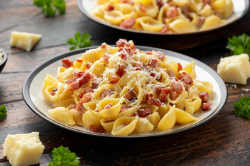 Classic Pasta carbonara with bacon, egg, cream, black pepper and Parmesan Cheese on plate. Italian food
