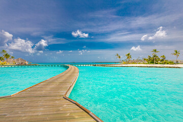Maldives island, luxury water villas resort and wooden pier jetty. Beautiful sky and clouds and beach background for summer vacation holiday and travel concept. Tourism adventure destination seaside