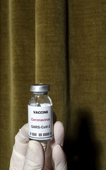 Covid-19 vaccine with syringe in the hands of unrecognizable doctor