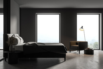 Dark bedroom interior with bed and armchair near window