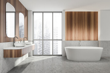 Fototapeta na wymiar Bathroom interior with two sinks and bathtub near window