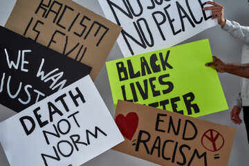 Banners with anti racist phrases held by people