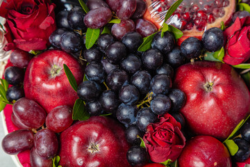 Naklejka na ściany i meble Juicy, fresh fruits, dark grapes and red apples, beautifully presented. Close-up