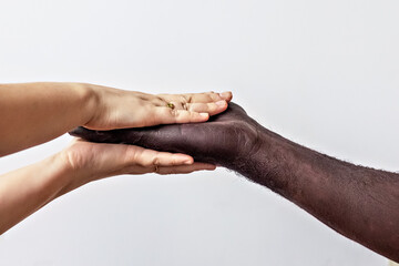 Black male and white female hands, open palms to each other. A symbol of the struggle for black rights in America. The concept of equality and the fight against racism