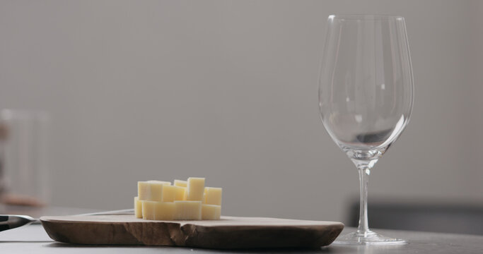 vintage cheese on oliveboard with wine glass