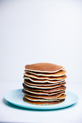 Stack of Tasty pancakes on white background