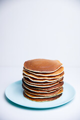 Stack of Tasty pancakes on white background
