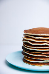 Stack of Tasty pancakes on white background